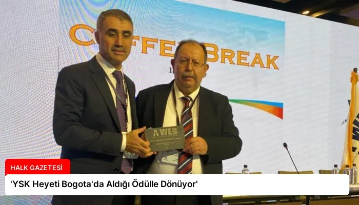 ‘YSK Heyeti Bogota’da Aldığı Ödülle Dönüyor’